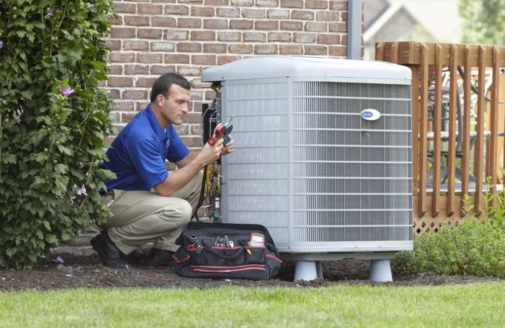AC repair technician working on an outdoor unit