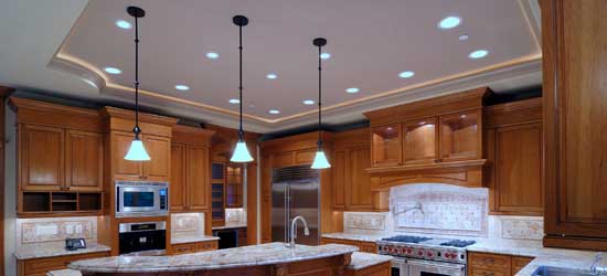 Kitchen with wooden cabinets and modern lighting, including recessed lighting